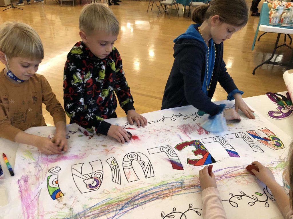 children decorate an alleluia banner